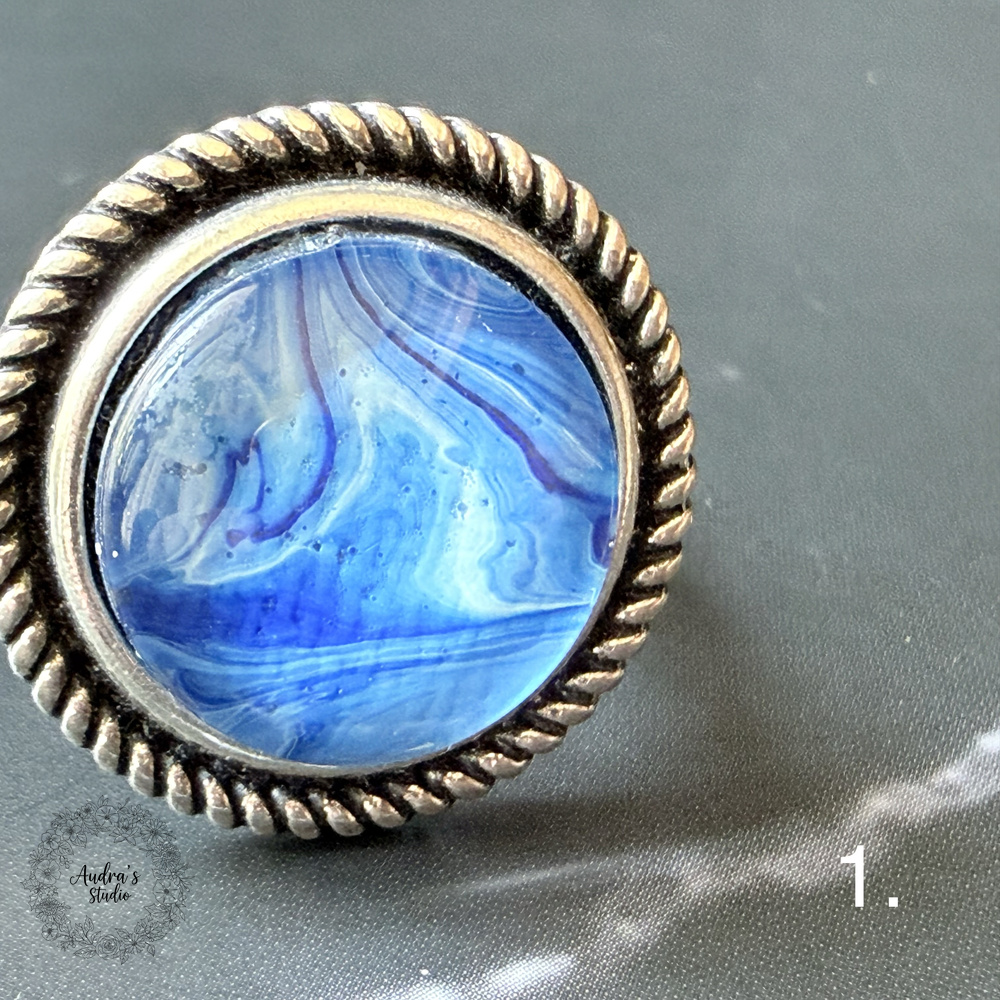 Hand-poured acrylic fluid art ring number 1 in an antique silver adjustable rope-edge setting
